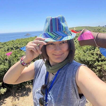 Website creator Zara wearing a brightly coloured hat