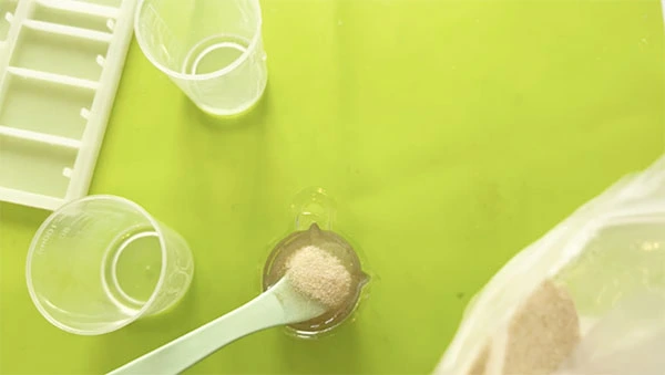 Sand and resin in a mixing cup