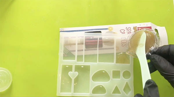 Sand and resin mixture being poured into a silicone mould