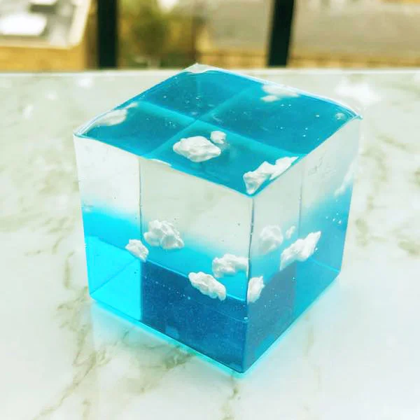 clouds encased in a blue and clear resin cube