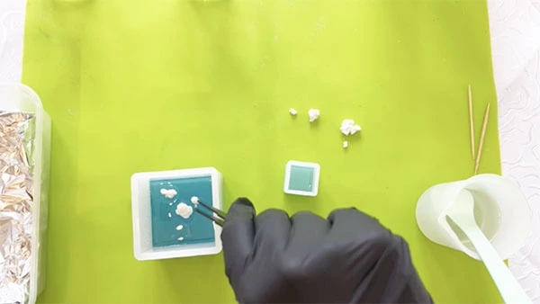Clouds being placed in silicone mould with tweezers