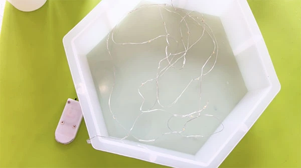 Large hexagonal silicone mould with thin string of fairy lights inside