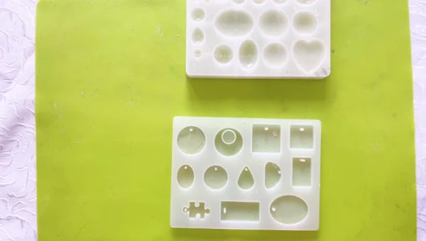 Resin moulds in various small shapes filled with clear resin