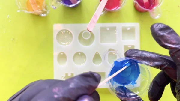Small pots of brightly coloured resin