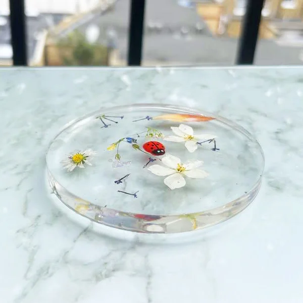 Resin coaster with flowers embedded in it